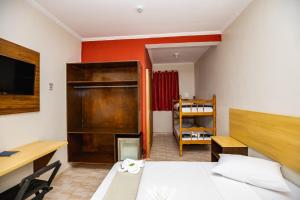 a small room with a bed and a desk and a room with a desk at Hotel Venice Ubatuba in Ubatuba +129 photos