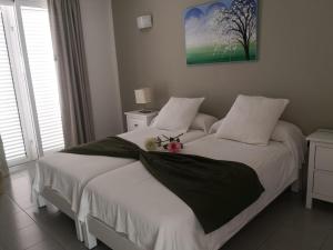 a bedroom with a bed with a stuffed animal on it at Apartamentos El Guirre in Valle Gran Rey