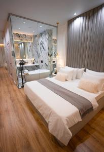 a bedroom with a large bed with a large mirror at Suite Hotel in Kemerovo