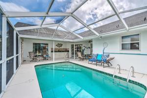 a swimming pool with a glass roof over a patio at Waterfront Home with Dock, Kayaks, Pool and More! in Crystal River