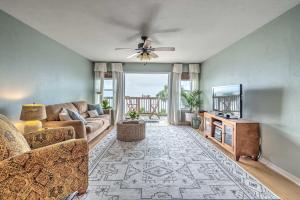 a living room with a couch and a tv at Charming Cedar Key Condo Direct Beach Access in Cedar Key