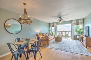 a living room with a table and chairs and a couch at Charming Cedar Key Condo Direct Beach Access in Cedar Key