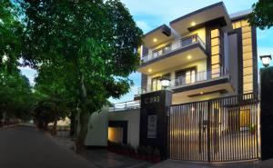 a white building with a fence in front of it at Perch Arbor Suites in Gurgaon