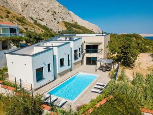 an aerial view of a house with a swimming pool at Villa Perla Nera & Villa Nevera by Pag tours in Stan Trigraci
