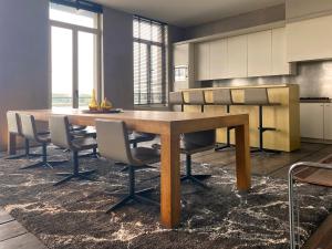 a kitchen with a wooden table and chairs at Loft O - River View in Antwerp