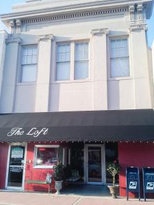 a building with a sign that reads the left at The Loft on the Square in Magnolia