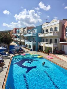 a large swimming pool in a residential area at Epis Hotel in Agia Marina Nea Kydonias