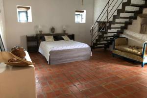 a bedroom with a bed and a staircase at Mas historique du XVe Cevennes in Saint-Paul-la-Coste