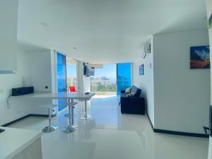 a white kitchen with a table in a room at Tom Ocean Club con vista al mar piso 15 bello horizonte santa marta carrera 3 #110-55 bello orizonte santa marta in Gaira