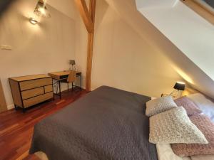 a bedroom with a bed and a desk with a table at Apartamenty Milenijna 2 MALBORK Nowa Wieś in Malbork +75 photos