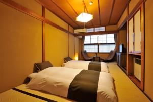 Posteľ alebo postele v izbe v ubytovaní Hida Takayama Hodakaso Yamano Iori
