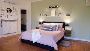 a bedroom with a bed with a shelf on the wall at Lavena - LAKE & MOUNTAIN Apartments in Lavena Ponte Tresa