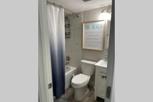a bathroom with a toilet and a tub and a sink at Siesta Key Village-Suite #4: A block to the Beach! in Sarasota +12 photos
