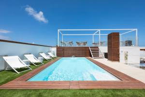 a swimming pool on the roof of a house at Cotillo House in El Cotillo