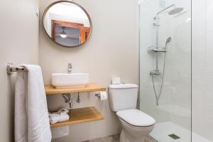 a bathroom with a toilet and a sink and a mirror at Cotillo House in El Cotillo