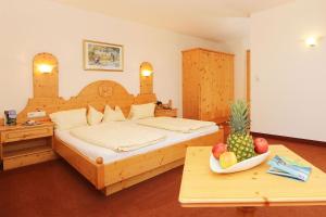 a bedroom with a bed and a bowl of fruit on a table at Waldele in Sölden