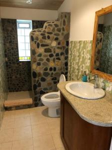 a bathroom with a sink and a toilet at IntiRumi Inn in Caraz