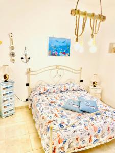 a bedroom with a bed with blue pillows on it at Relax House in Bari