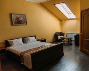 a bedroom with a bed and a skylight at Forest club Sherwood in Uman