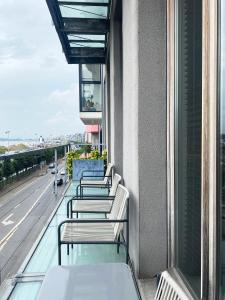 a row of benches sitting on the balcony of a building at Loft O - River View in Antwerp