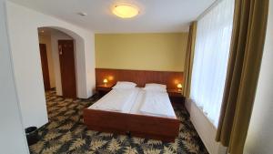 Postel nebo postele na pokoji v ubytování Hotel Der Tannenbaum
