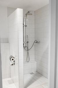 a bathroom with a shower with a glass door at Bach Hotel in Porta Westfalica