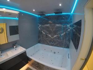 a bathroom with a tub and a sink and a mirror at Perfect Central London Base in London