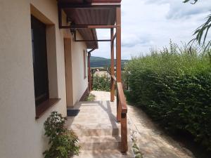 a walkway leading up to a building with a view at Vértestolna Vendégház in Vértestolna