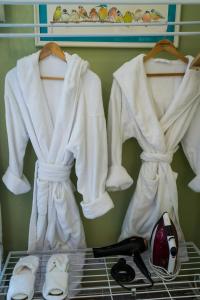 a group of white clothes hanging on a rack at Idyllic Suite at Lower Fields Farm in Napton on the Hill