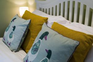 a bed with two pillows withrenderedrenderedrenderedrenderedrenderedrenderedrendered at Idyllic Suite at Lower Fields Farm in Napton on the Hill