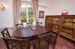 a dining room with a wooden table and chairs at Ampelaki Blue in Paleokastritsa