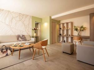 a living room with a couch and a table at ibis Styles Beaulieu sur Mer in Beaulieu-sur-Mer