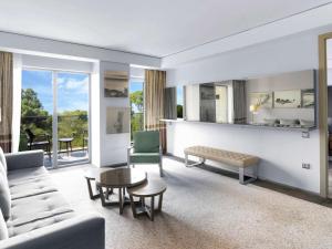 a living room with a couch and a table at Rixos Premium Belek - The Land of Legends Access in Belek