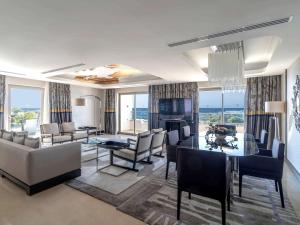 a living room with a table and a dining room at Rixos Premium Belek - The Land of Legends Access in Belek
