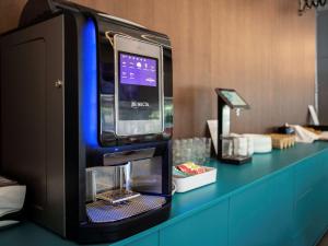 a pay phone sitting on top of a counter at IBIS Styles Kaunas Centre in Kaunas