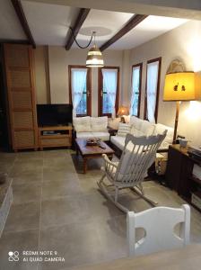 a living room with a couch and a tv at Natali's Villa by the sea in Kato Gatzea