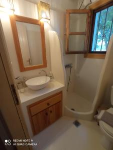 a bathroom with a sink and a tub and a toilet at Natali's Villa by the sea in Kato Gatzea