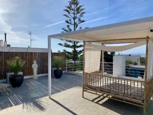 a patio with a white canopy and some plants at Ibiza style house,6 pers, luxury,with private pool in Sant Josep de sa Talaia