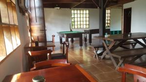 a group of tables and chairs in a room at Gran Camping Cabanas da Fazenda in Visconde De Maua