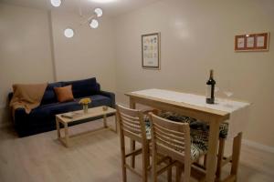a living room with a table and a blue couch at RecoBerta Studio. Vivir Recoleta!! in Buenos Aires +19 photos