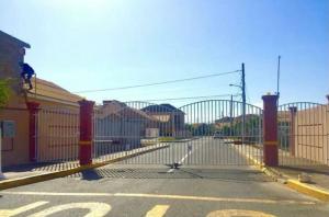 a fence with a gate in front of a street at Luxurious Secret Escape in Portmore
