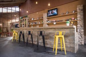 a row of yellow stools at a bar at AVA Valle Sagrado Spot in Urubamba