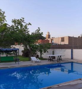 a swimming pool with a bench and a picnic table at Montemira Private House in Ica