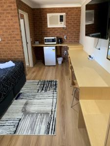 a small room with a kitchen and a living room at Colonial Motor Inn in West Wyalong