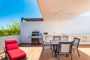 a living room with a dining room table and chairs at Entire House- 3BR with Private Roof Top Deck in Playa del Carmen