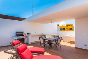 a living room with a table and chairs and a kitchen at Entire House- 3BR with Private Roof Top Deck in Playa del Carmen