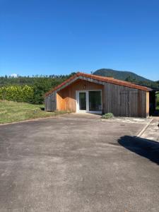 a building with a large parking lot in front of it at Le Chalet dans la Nature in Saulcy-sur-Meurthe