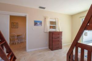 a room with a staircase and a dresser and a table at 3606 Villa Franca - Pet Friendly in Sarasota