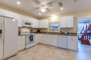 a kitchen with white appliances and a ceiling fan at 3606 Villa Franca - Pet Friendly in Sarasota