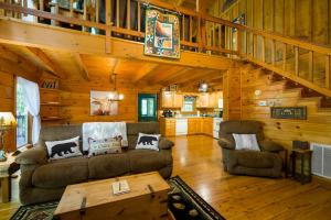 a living room with a couch and chairs in a cabin at GYPSY ROAD - Privacy! Log Cabin with Hot Tub, WiFi, DirecTV and Arcade in Sevierville